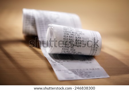 Grocery shopping list till roll printout on a wooden table