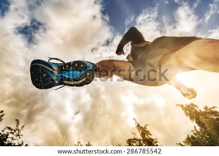 Outdoor cross-country running low angle view under runner concept for exercising, fitness and healthy lifestyle