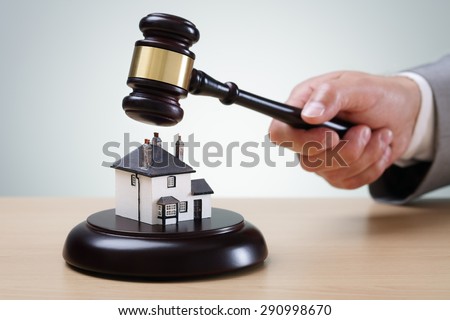 Bidding on a home, gavel and house concept for home ownership, buying, selling or foreclosure