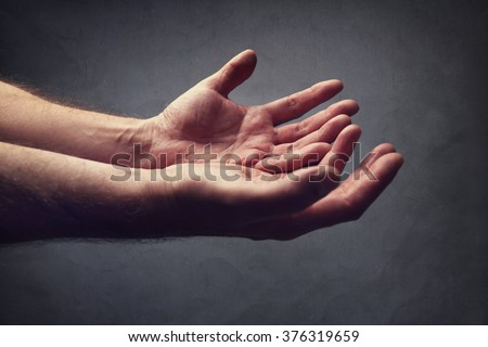Hands reaching out concept for help, religion, salvation, forgiveness, assistance and love or begging