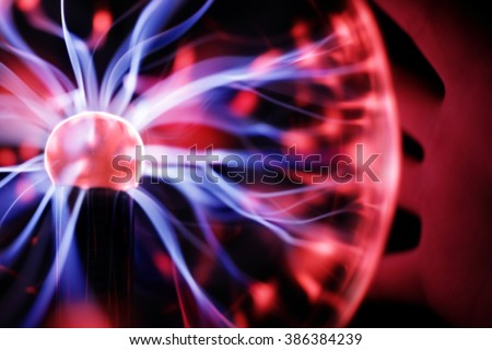 Plasma ball lamp energy, hand touching glowing glass sphere concept for power, electricity, science and physics