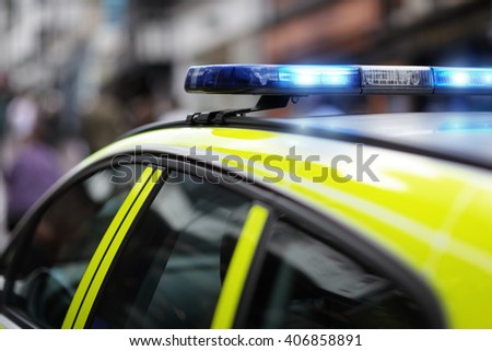 Police siren flashing blue lights at accident or crime scene