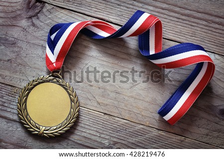 Gold medal on wood background with blank face for text, concept for winning or success