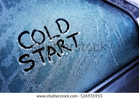 Cold start message written on frozen car windshield window