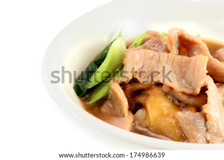 Fried noodle with pork and kale soaked in gravy, Thailand food on a white round bowl isolated over white background. Top view.