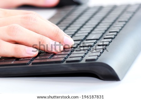 Office worker typing on the keyboard, close up