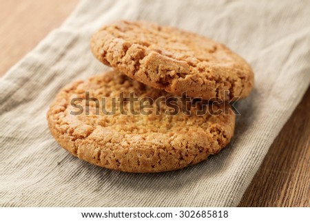 Pastry biscuits on linen napkin on wooden table. Pastry biscuits shot on coffee colored cloth, closeup with selective focus.