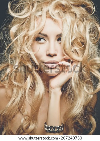Beautiful woman with magnificent blond hair. Hair extension, permed