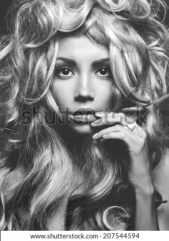 Black and white portrait of a beautiful woman with magnificent blonde hair. Hair extension, permed.