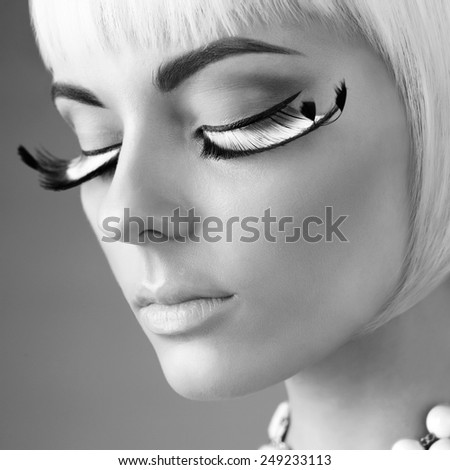 Black and white closeup portrait of lady with beautiful eyelashes