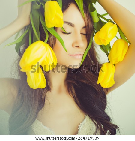 Fashion art portrait of beautiful lady with delicate flowers