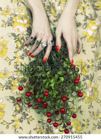 Woman\'s hands holding a bouquet of berry. Fashion art photo. Beauty and Manicure