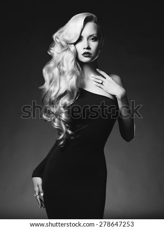 Black and white fashion art photo of elegant blonde on black background