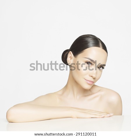 Studio portrait of beautiful young woman with perfect skin. Beauty and care. Spa salon