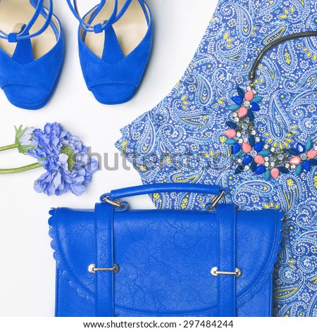 Stylish woman outfit in blue colors on white background