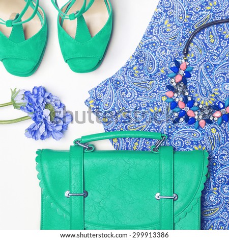 Stylish woman outfit in blue and green colors on white background