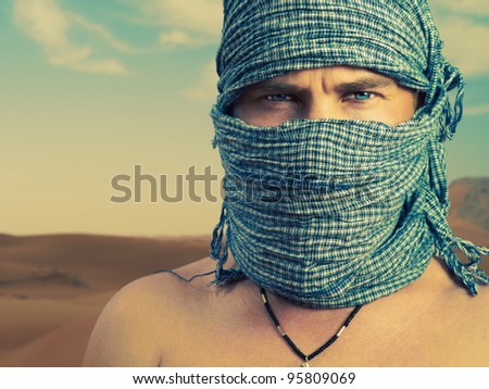 Photo of a man in Bedouin scarf in desert