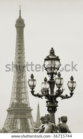Street lantern on the Alexandre III Bridge against the Eiffel Tower in Paris, France.