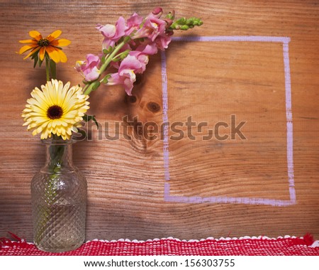Flowers against a wooden background for texture with chalk outlines for copy space.