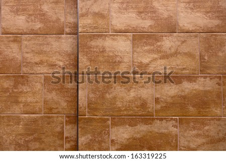 A flat wall made with textured stone tiles with lots of detail and texture for background.