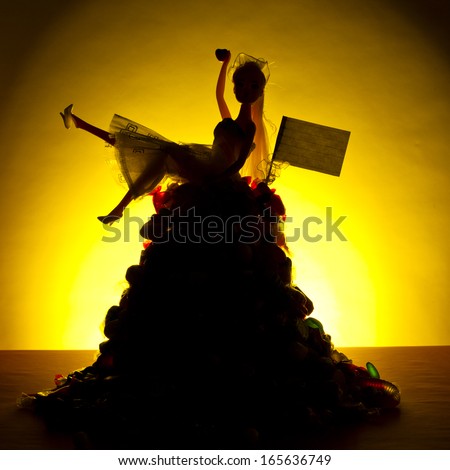 A generic toy doll bride silhouette is seated on top of large pile of candy against a warm yellow background.