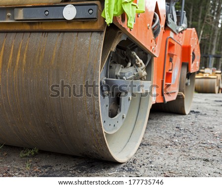 A construction vehicle steam roller close up.