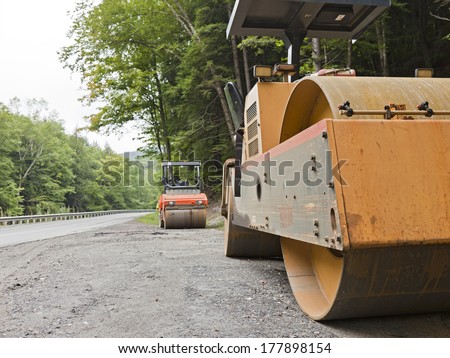 Rural road repair with steam rollers.