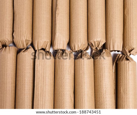 An arrangement of cardboard wrapped products ready to be shipped against a white background.