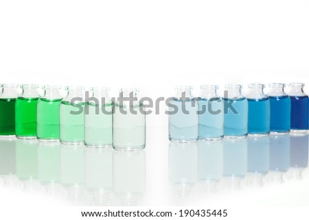 Two diagonal lines of science vials transitioning from a dark green to light green and the other from light blue to dark blue against a white background.