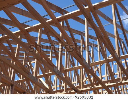 low angle view of roof trusses and framing of new house construction