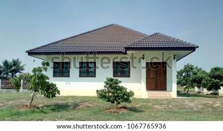 Single storey house.  Isolated single storey house. Front View of one floor single family house. Asia style design.