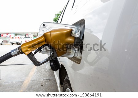 Close-up fuel nozzle.  Fill up fuel at gas station