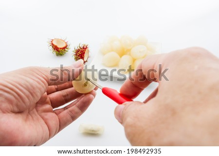 Hand peeling rambutan fruits , remove the tough central part and seeds from fruit.