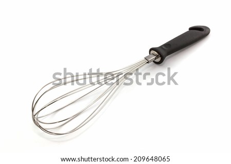 Metal whisk for whipping eggs on white background, House ware.