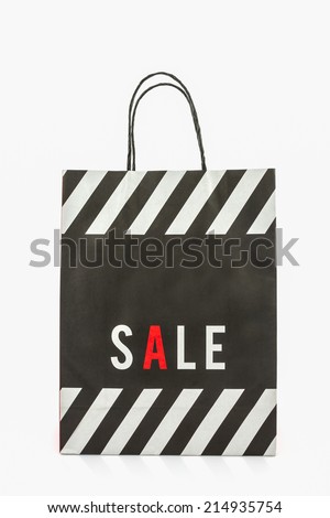 Black paper shopping bag on white background.
