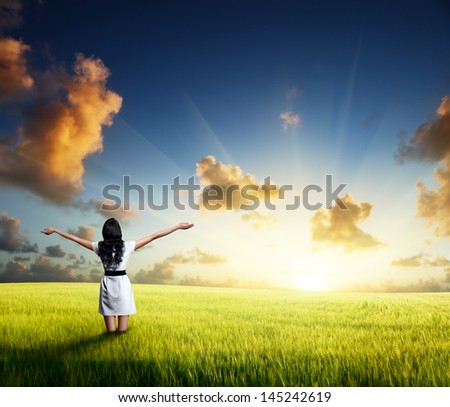 happy young woman in white dress standing in field