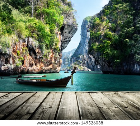 long boat and rocks on railay beach in Krabi, Thailand