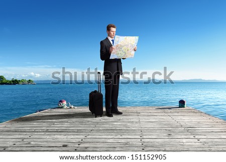 Business man standing on pier with map in hands