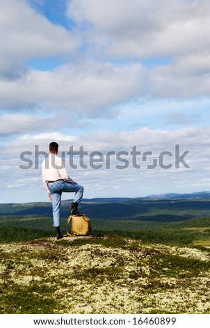 traveler on top of mountain of north tundra