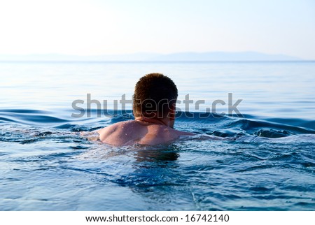 morning light and swimming man in ocean