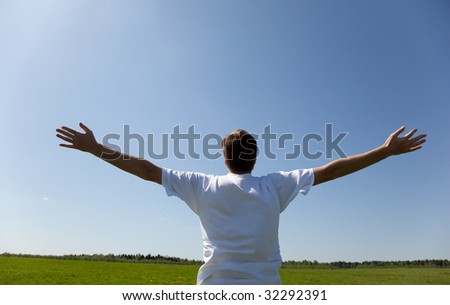 happy young man and spring field