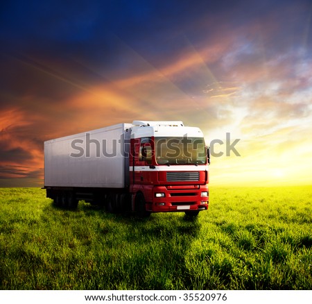 field of grass in sunset and truck