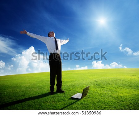 happy young businessman on spring field