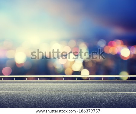 Asphalt road and blurred modern city