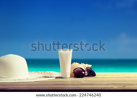 Sun lotion and sunglasses on the beach