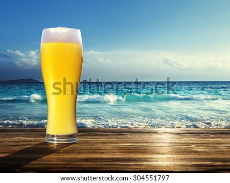 fresh  unfiltered beer and tropical beach