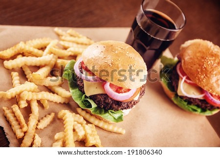 Ground beef Cheese Burger with Lettuce,Tomato and Red Onion with French Fries .