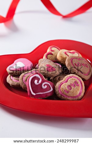 Heart Shape Cookies On Red Plate With Red Ribbon Behind