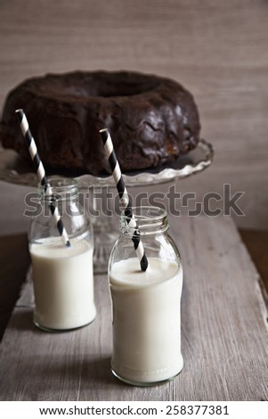 Two Bottles Of Milk With Straws And Bundt Cake. Focus Is On Bundt Cake.