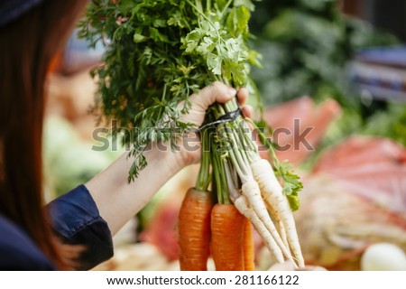 Close Up Woman\'s Hand Choosing Vegetables At Market Place